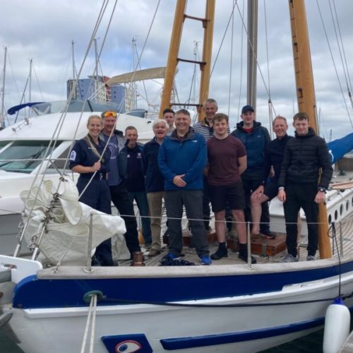 Boleh in dock with people standing on her