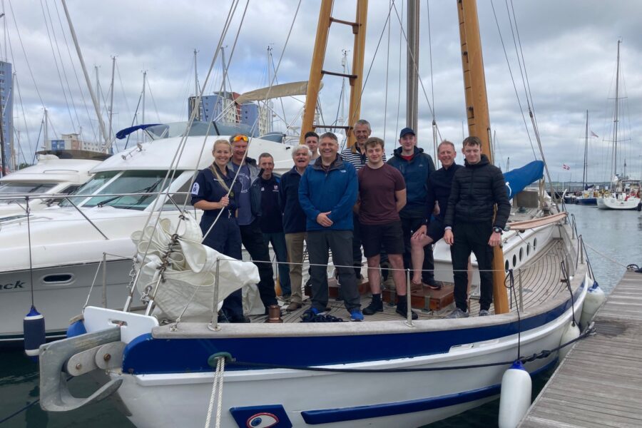 Boleh in dock with people standing on her