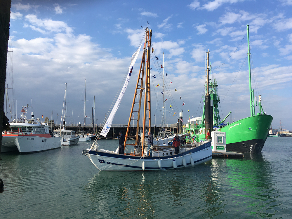 Boleh and volunteer crew putting out the bunting on return to her Haslar berth.